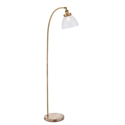 Floor lamp in antique brass finish with clear glass shade and adjustable knuckle joint