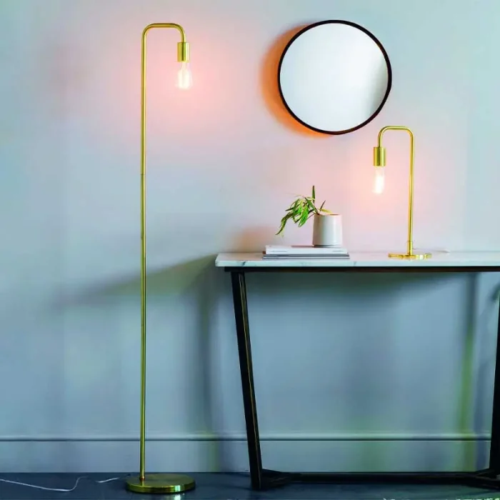 Floor lamp in a brushed brass finish showcases a clean line design