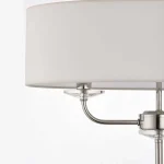 Floor lamp in bright nickel finish with vintage white faux silk shade