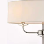 Floor lamp in bright nickel finish with vintage white faux silk shade