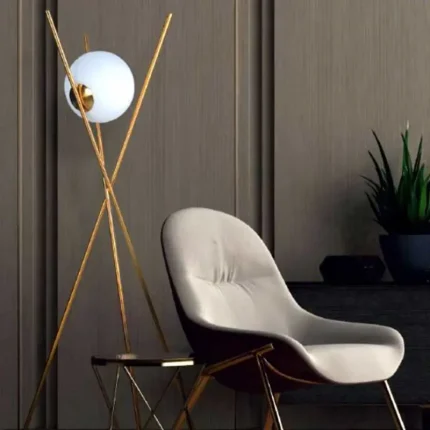 Tripod design floor lamp in brass finish with white shade