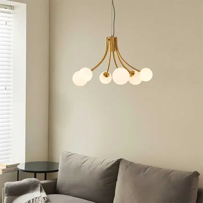 Pendant light in brushed gold finish with white glass shades