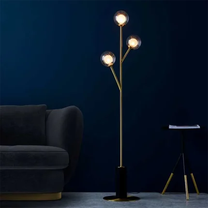 Floor lamp made from satin brass plated metalwork with matt black details