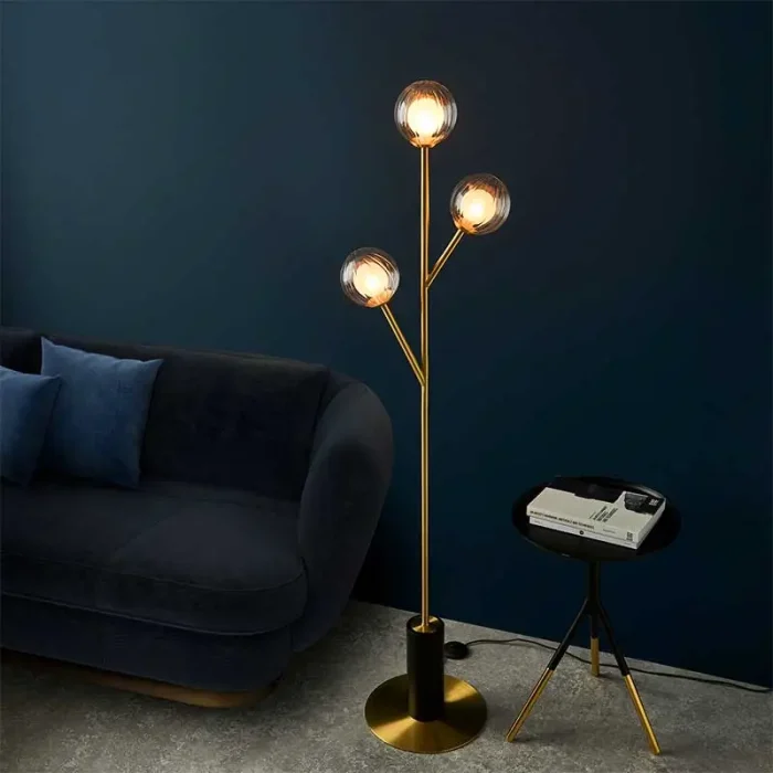 Floor lamp made from satin brass plated metalwork with matt black details