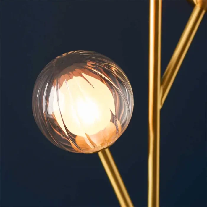 Floor lamp made from satin brass plated metalwork with matt black details