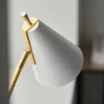 Adjustable head table lamp in matt white and satin brass finish for bedroom, living room, dining room or hallway