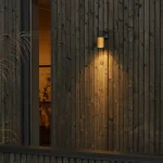 Black and gold down outdoor wall light for patio, entrance and garden areas