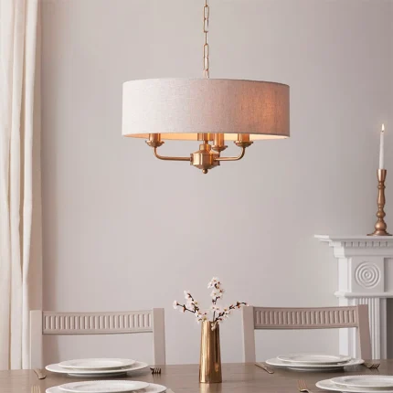 Pendant light in aged brass finish with natural linen fabric shade