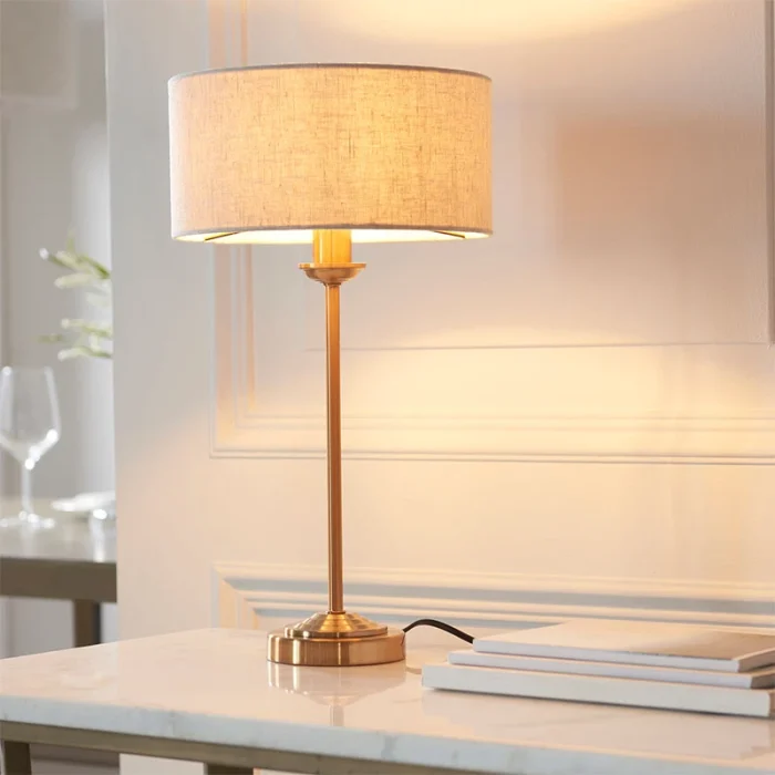 Table lamp in aged brass finish with natural linen fabric shade