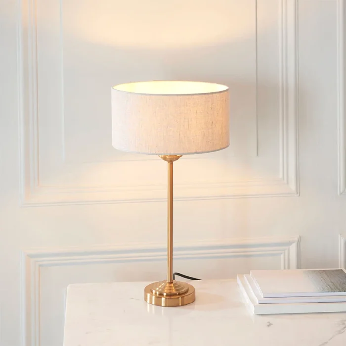 Table lamp in aged brass finish with natural linen fabric shade