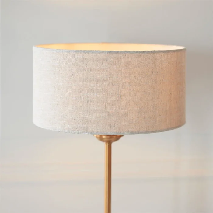 Table lamp in aged brass finish with natural linen fabric shade