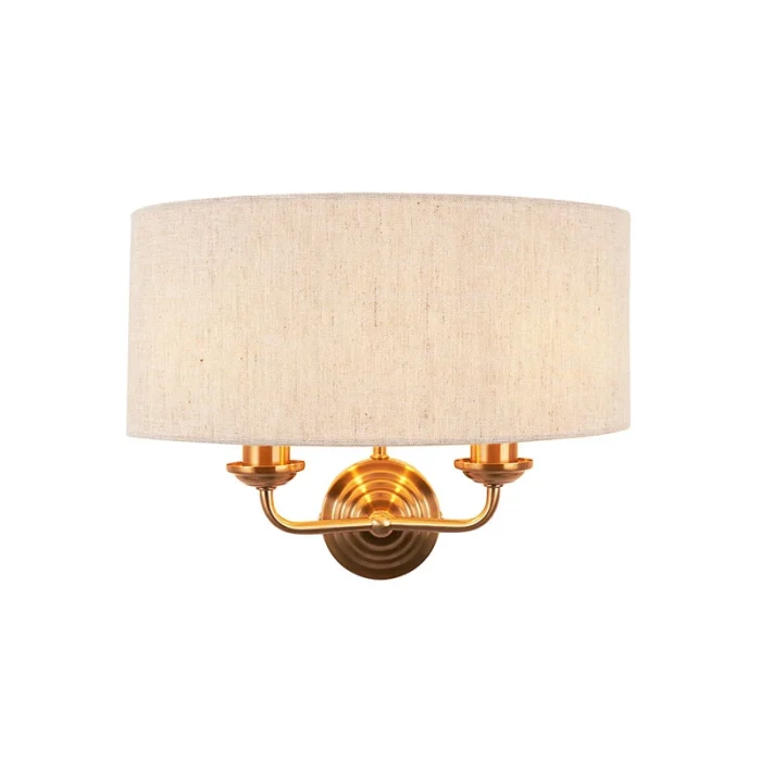 Wall light in aged brass finish with natural linen fabric shade