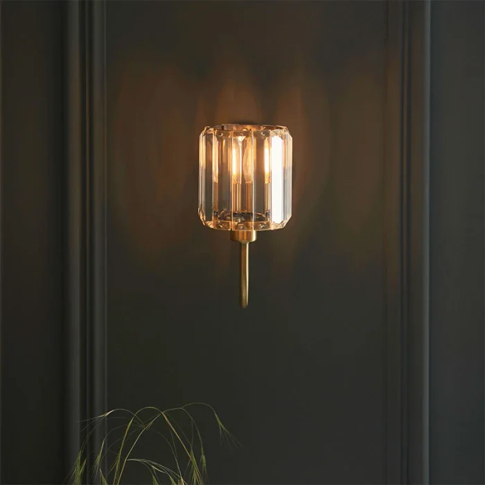 Wall light in antique brass plated finish