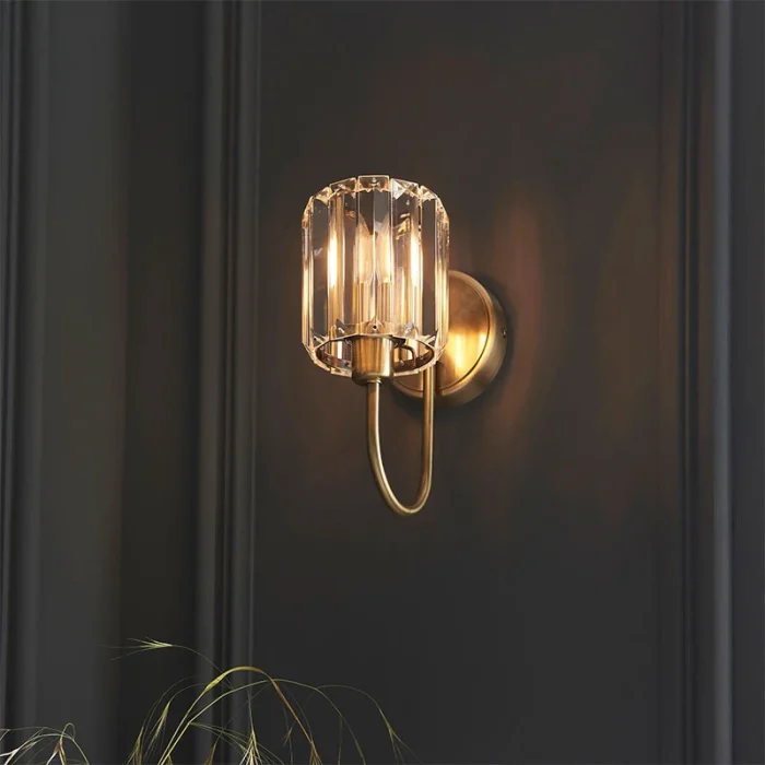 Wall light in antique brass plated finish