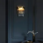 Wall light in antique brass plated finish with clear glass rods