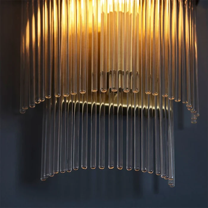 Wall light in antique brass plated finish with clear glass rods