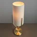 Table lamp in satin brass finish with natural linen fabric shade