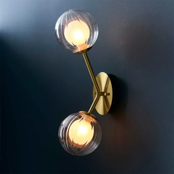 Wall light in satin brass finish with clear ribbed glass