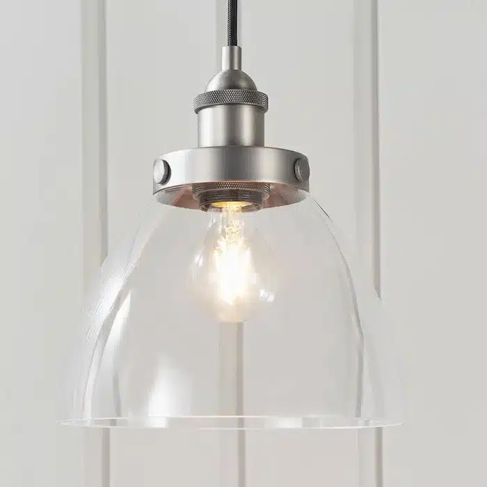 Single pendant light in brushed silver finish with clear glass shade