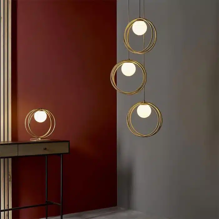 Brushed gold globe pendant light opal glass shades in living room