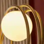 Brushed gold globe pendant light ring detailing