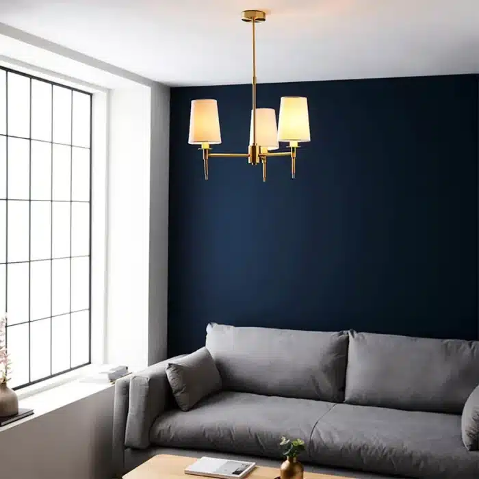 Satin brass pendant light with vintage white shades in living room