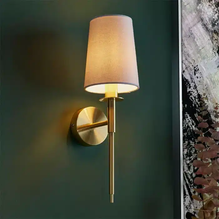 Satin brass wall light with vintage white fabric shade lifestyle image