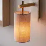 Brass marble effect wall light with linen shade close up