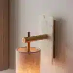 Brass marble effect wall light with linen shade close up downwards