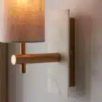 Brass marble effect wall light with linen shade close up upwards