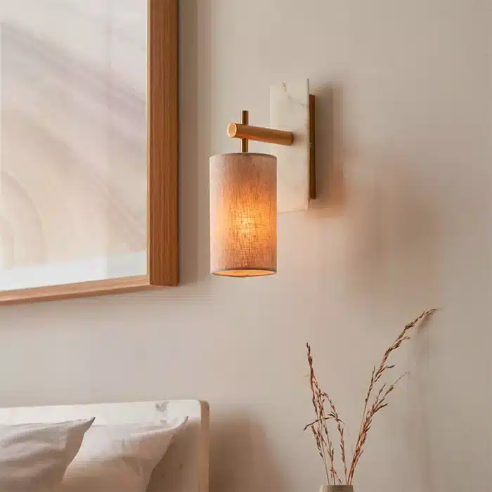Brass marble effect wall light with linen shade facing downwards