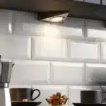 Matt black triangular LED under cabinet light in kitchen